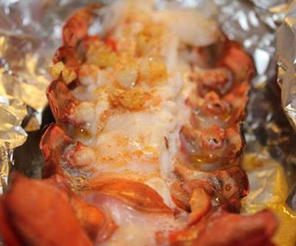 Wrap our lobster tails loosely in foil after adding garlic butter & grill or bake for 12 mins small or 22 mins large.